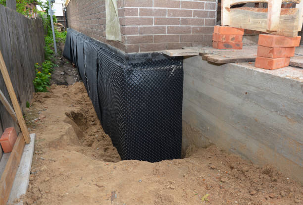 Happy homeowners after waterproofing job in Rives Junction